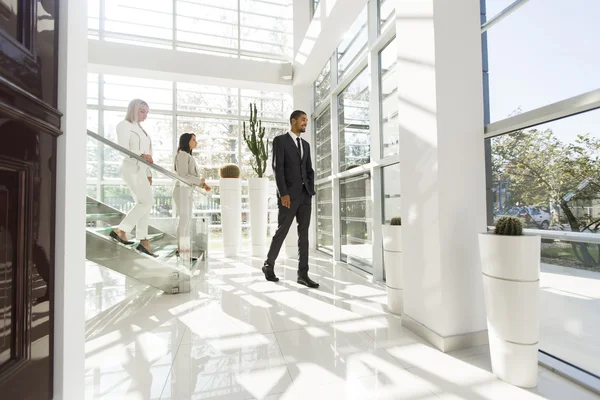 Young people walking in the office — Stock Photo, Image