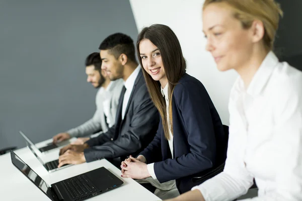Businesswoman sitting with her colleagues — Stock Photo, Image