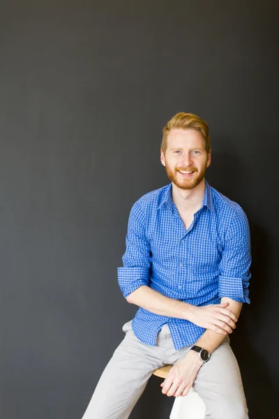 Man posing on the chair — Stock Photo, Image