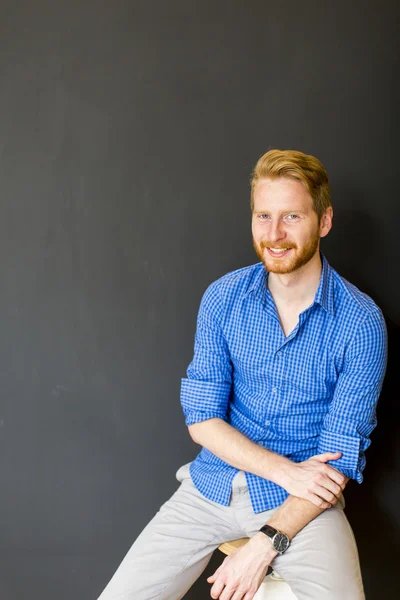 Man posing on the chair — Stock Photo, Image