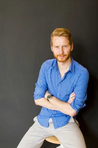 Man posing on the chair — Stock Photo, Image