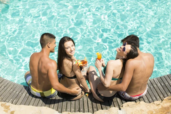 Young people by the pool — Stock Photo, Image