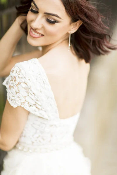 Young woman by the fence — Stock Photo, Image