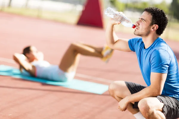 Young man drinking water — Stock Photo, Image