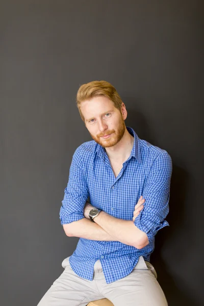 Man posing on the chair — Stock Photo, Image