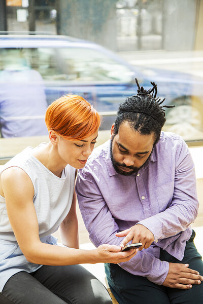 Multiracial couple using smartphone