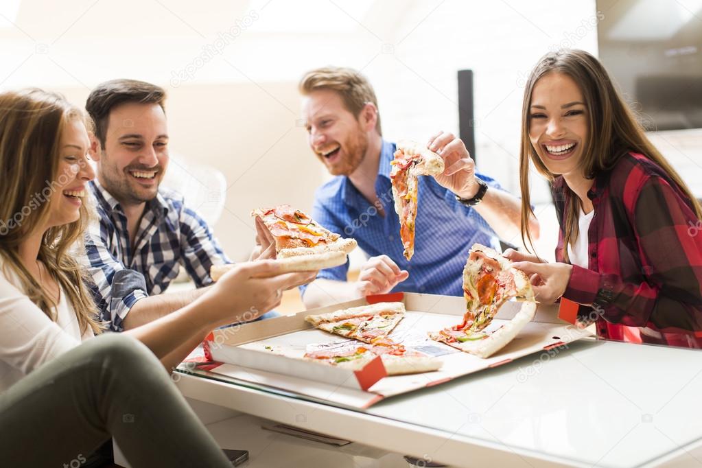 Group Of Friends Eating Pizza Together At Home Stock Photo, Picture and  Royalty Free Image. Image 56950664.