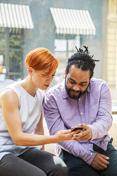 Multiracial couple using smartphone