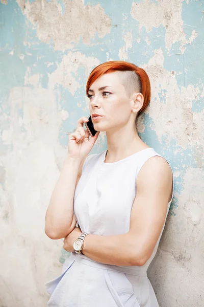 Junge Frau mit rotem Haar an der alten Mauer — Stockfoto