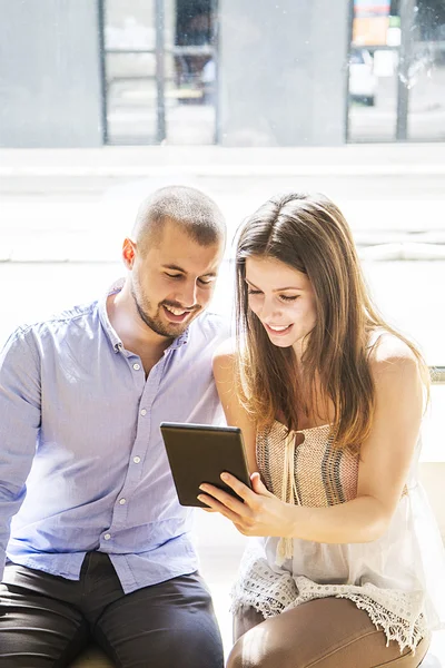 Young couple with tablet — Stock Photo, Image