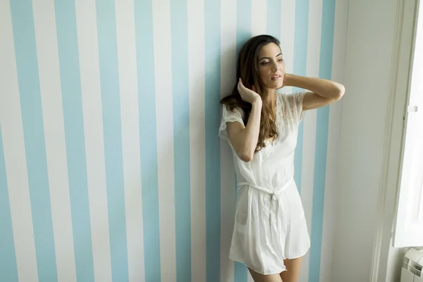 Young woman by the window — Stock Photo, Image