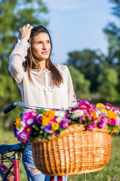 Young girl with a bicycle — Stock Photo, Image