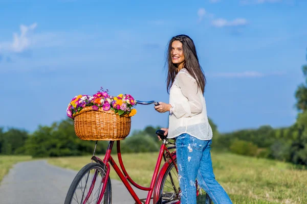 Young girl with a bicycle — Stock Photo, Image
