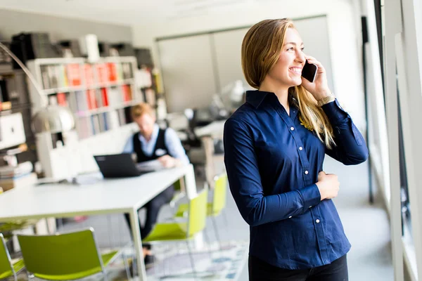 Woman with telephone in the office — Stock Photo, Image