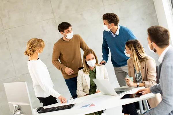 Group of business people have a meeting and working in the office and wear masks as protection from corona virus