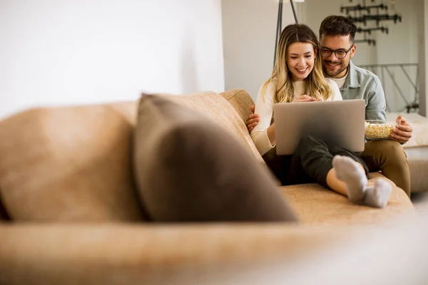 Handsome Young Couple Using Laptop Together While Sitting Sofa Home — Stock Photo, Image