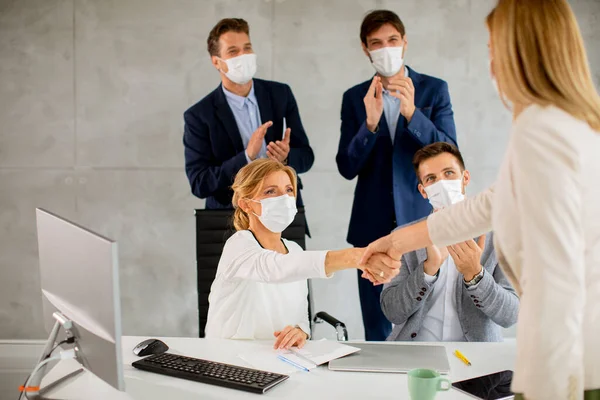 Group of business people have a meeting and working in the office and wear masks as protection from corona virus