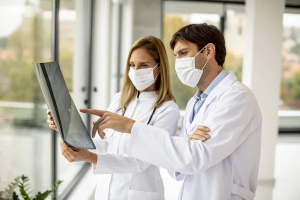 Läkare Med Skyddande Ansiktsmasker Som Undersöker Röntgen Kontoret — Stockfoto