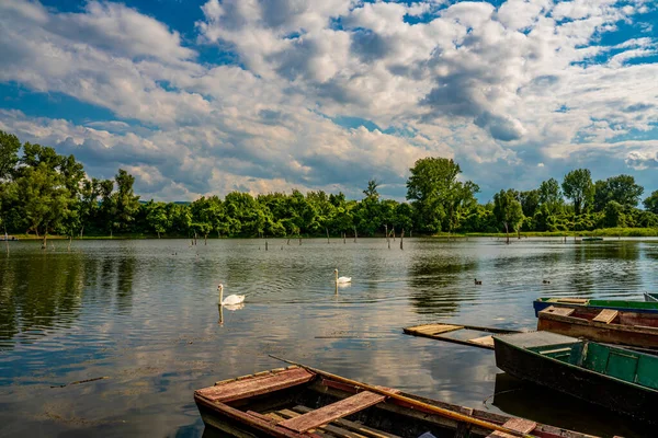 Small wooden boats on the calm lake