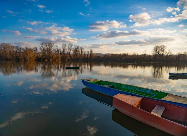 Small wooden boats on the calm lake