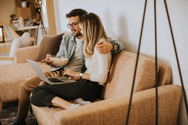 Handsome Young Couple Using Laptop Together While Sitting Sofa Home — Stock Photo, Image