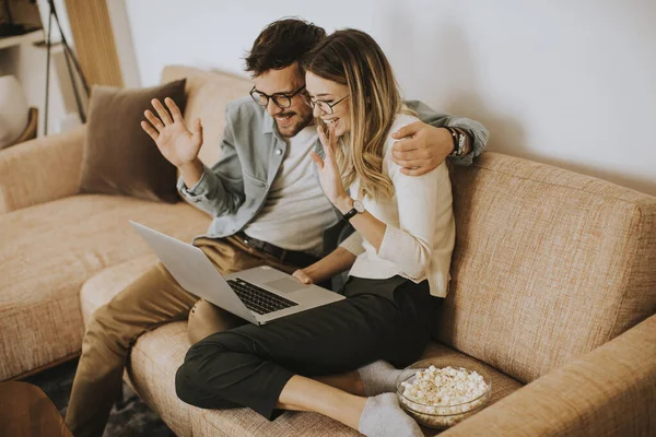 Handsome Young Couple Using Laptop Together While Sitting Sofa Home — Stock Photo, Image