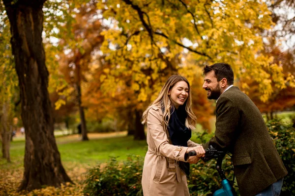 Bella Giovane Coppia Nel Parco Autunnale Con Bicicletta Elettrica — Foto Stock