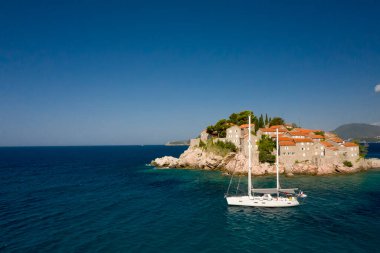 View at boat passing by Sveti Stefan islet in Montenegro