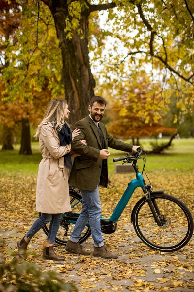 Flot Ungt Par Efterårsparken Med Elektrisk Cykel - Stock-foto