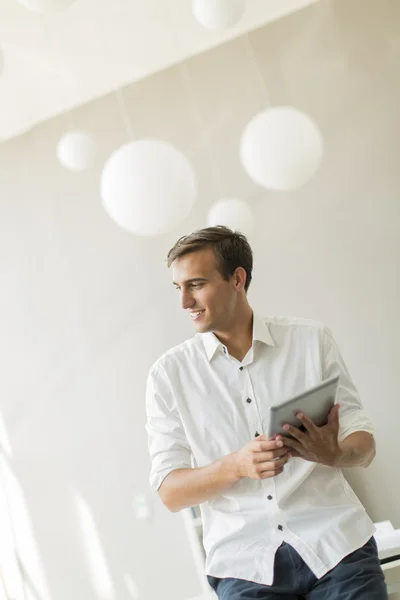 Young man with tablet in the office — Stock Photo, Image