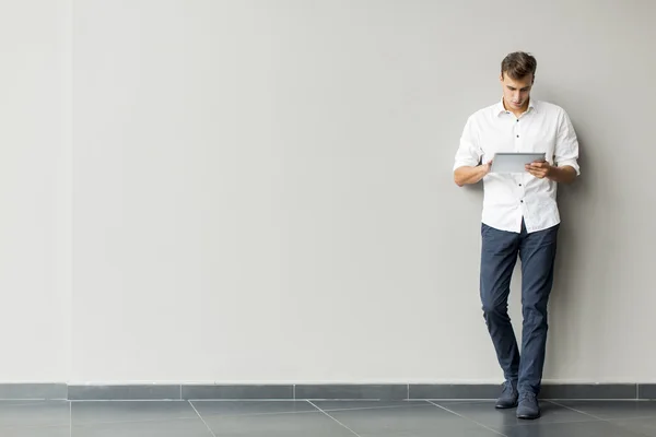 Man med tablet av väggen — Stockfoto