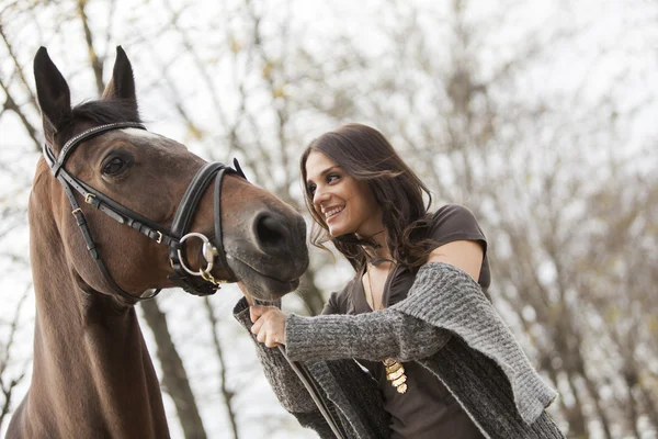 Young girl with a horse — Stock Photo, Image