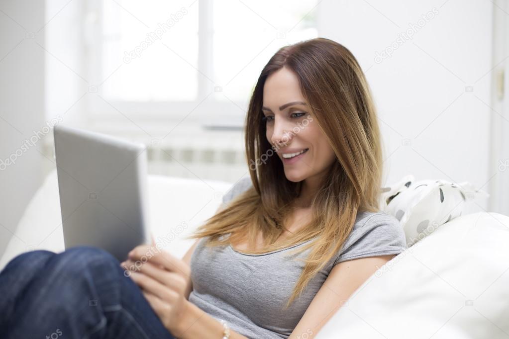 Young woman with tablet at home