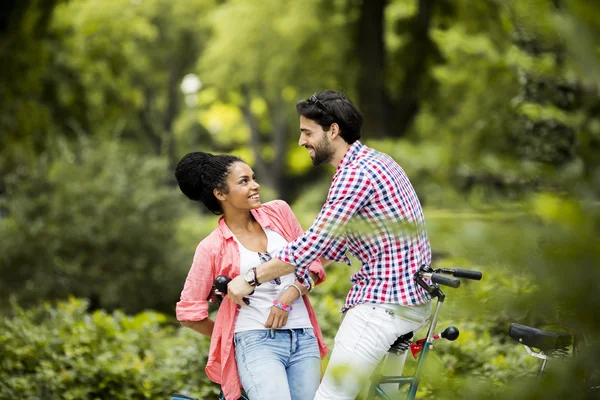 Young couple riding on the tandem bicycle — Stock Photo, Image