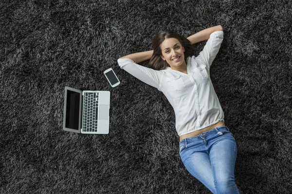 Woman laying on the carpet — Stock Photo, Image