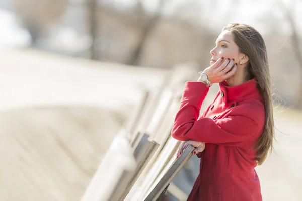 Pretty young woman in red coat — Stock Photo, Image