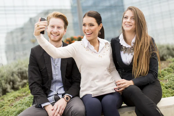 Young people taking photo with mobile phone — Stock Photo, Image