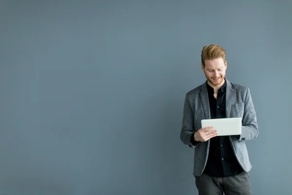 Hombre con tableta junto a la pared — Foto de Stock