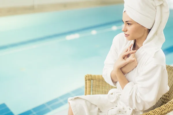 Mujer joven junto a la piscina — Foto de Stock