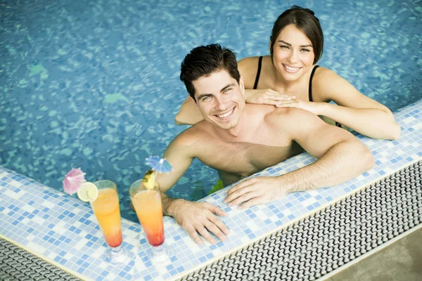 Young couple in the swimming pool — Stock Photo, Image