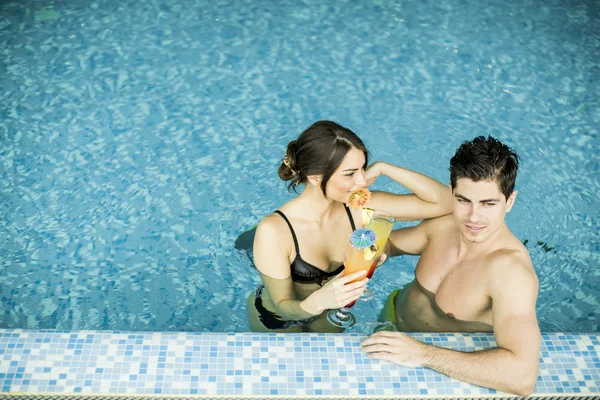 Young couple in the swimming pool — Stock Photo, Image