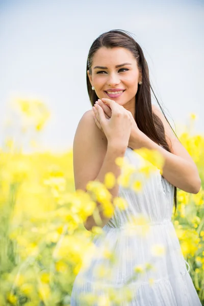 Young woman in the spring field — Stock Photo, Image
