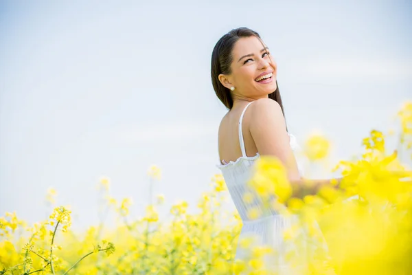 Young woman in the spring field — Stock Photo, Image