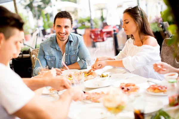 Jóvenes junto a la mesa — Foto de Stock