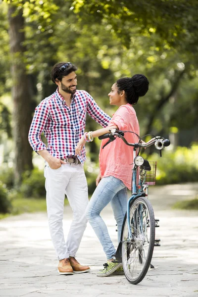 Young couple riding on the tandem bicycle — Stock Photo, Image