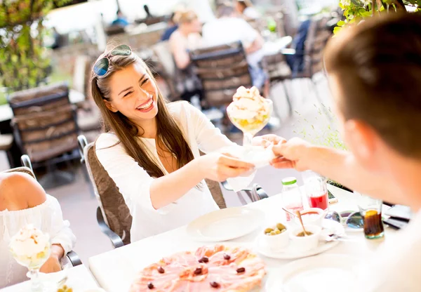 Young people by the table — Stock Photo, Image