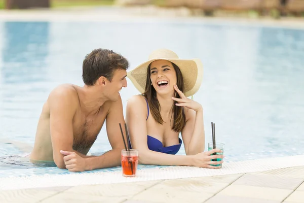 Young couple by the pool — Stock Photo, Image
