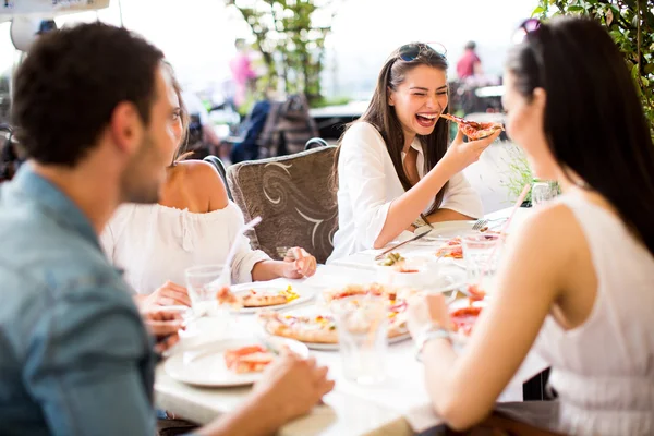 Young people by the table — Stock Photo, Image