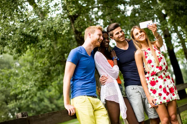 Young multiracial friends in the park — Stock Photo, Image