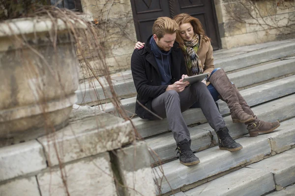 Young couple with tablet — Stock Photo, Image